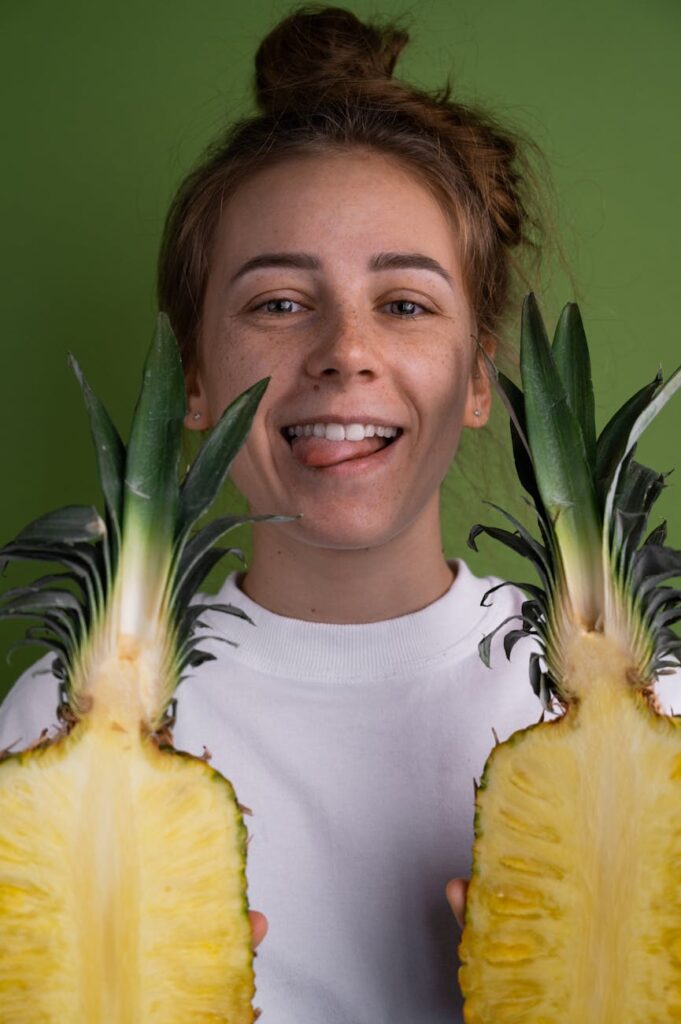 cheerful woman with cut pineapples