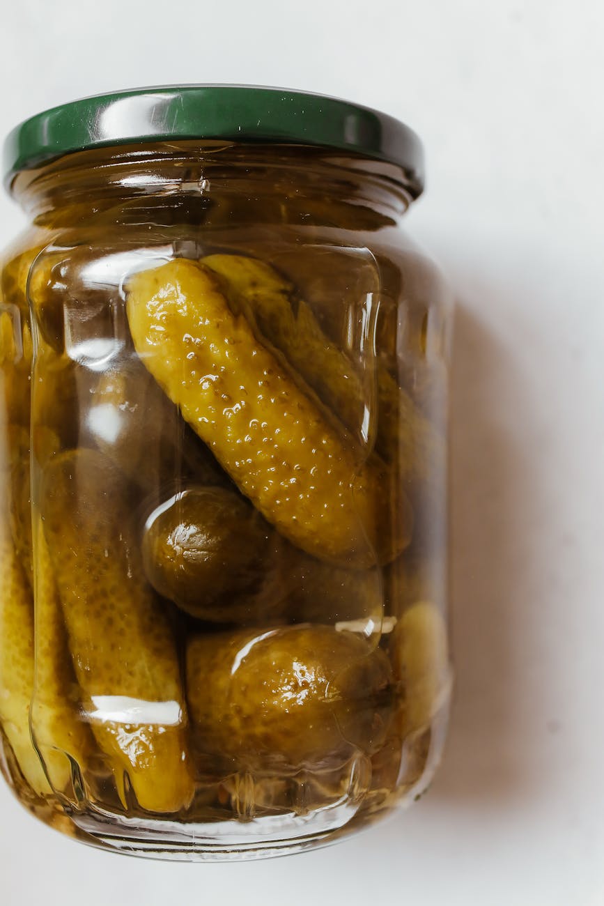 close up photo of pickles on a glass jar