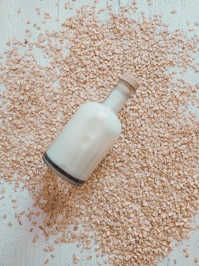 bottle of milk lying in oats