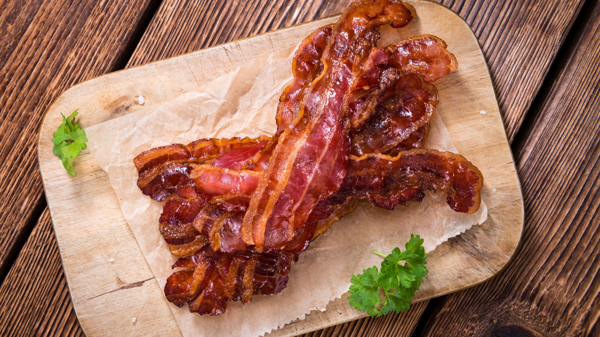 a pile of bacon on a cutting board