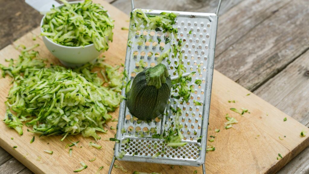Close-up of frozen grated courgettes in a labelled freezer bag